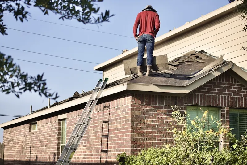 Professional roofer working on a residential roof in Wanamingo